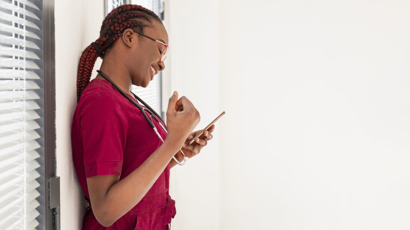 woman-medic-smiling-her-phone woman-medic-smiling-her-phone