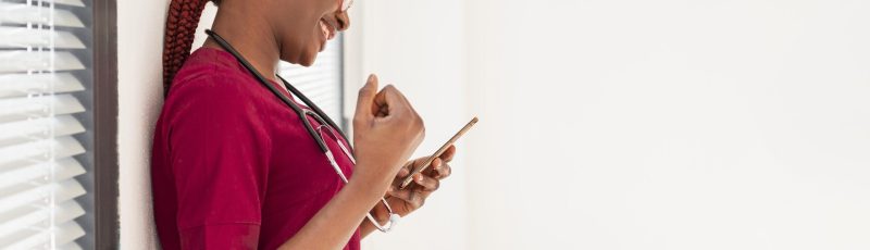 woman-medic-smiling-her-phone woman-medic-smiling-her-phone